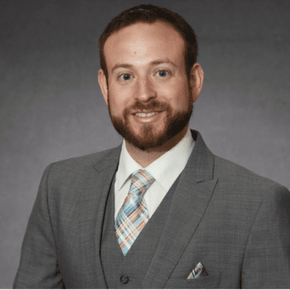 Dr. Jason Hawkins, board-certified family medicine physician, smiling in his office